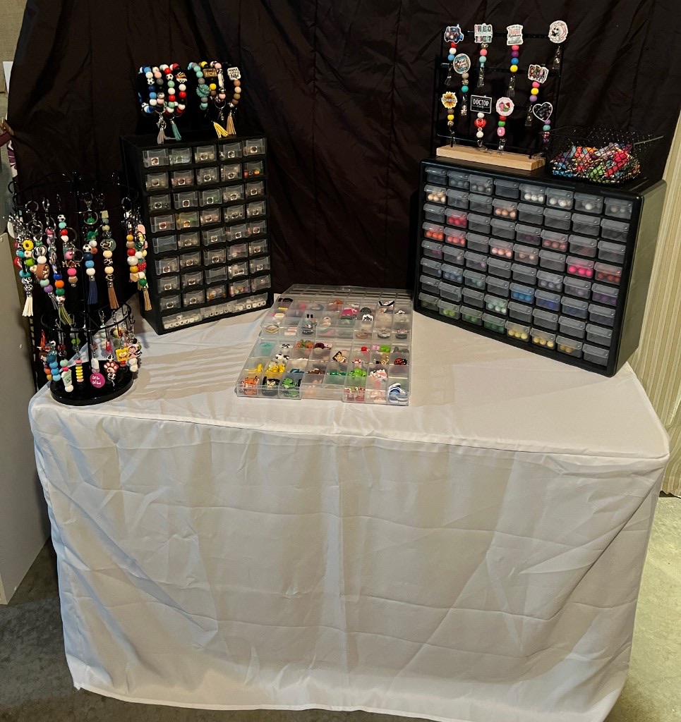 Once Upon a Craft Bead Bar table with sorted beads, charms, and finished keychains