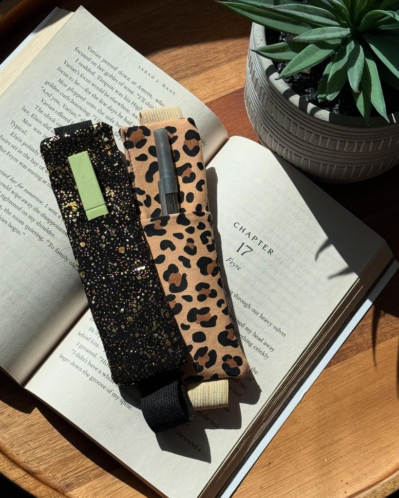 Handmade Pen Holder Bookmarks resting on an open book in sunlight